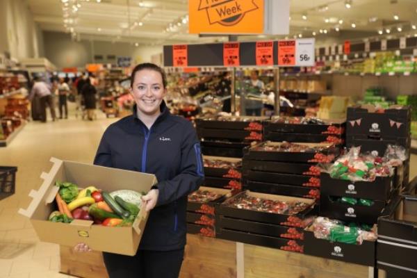 Lidl employee holding a Too Good To Waste box